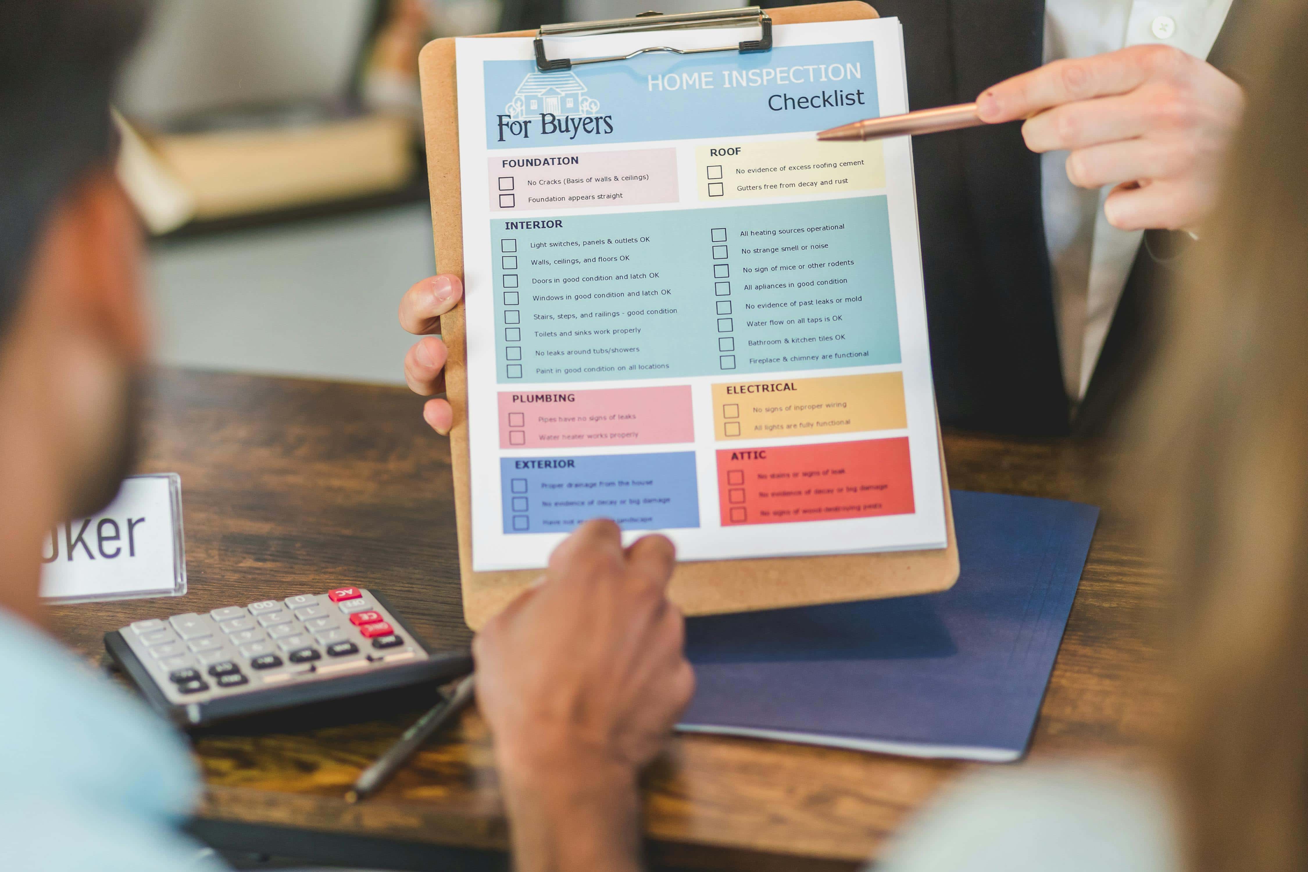Real estate agent interviewing potential clients with qualification checklist - qualified leads real estate